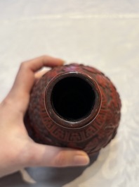 Two Chinese cinnabar lacquer covered boxes and a bottle vase, 19th C.