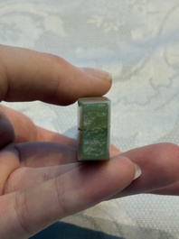 A Chinese celadon jade snuff bottle, a plaque and a ritual stick, Han and later