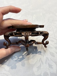 A Chinese celadon jade covered vase, with wooden stand, and a bowl with wooden cover and stand, 19/20th C.