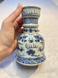 A pair of Chinese blue and white 'Dragons Chasing the Flaming Pearl&rsquo; candlesticks, 19th C.