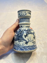 A pair of Chinese blue and white 'Dragons Chasing the Flaming Pearl&rsquo; candlesticks, 19th C.