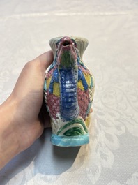 A Chinese famille rose ewer in the form of a dragon and two carps with wooden cover and stand, 19th C.