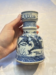 A pair of Chinese blue and white 'Dragons Chasing the Flaming Pearl&rsquo; candlesticks, 19th C.