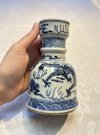 A pair of Chinese blue and white 'Dragons Chasing the Flaming Pearl&rsquo; candlesticks, 19th C.