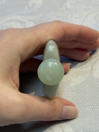 A Chinese celadon jade snuff bottle, a plaque and a ritual stick, Han and later