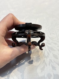 A Chinese celadon jade covered vase, with wooden stand, and a bowl with wooden cover and stand, 19/20th C.