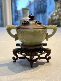 A Chinese celadon jade covered vase, with wooden stand, and a bowl with wooden cover and stand, 19/20th C.