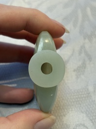 A Chinese celadon jade snuff bottle, a plaque and a ritual stick, Han and later