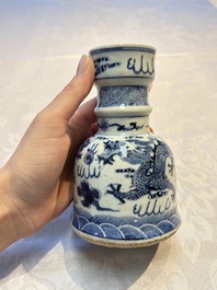 A pair of Chinese blue and white 'Dragons Chasing the Flaming Pearl&rsquo; candlesticks, 19th C.