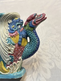 A Chinese famille rose ewer in the form of a dragon and two carps with wooden cover and stand, 19th C.