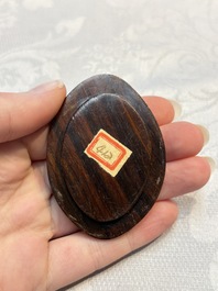 A Chinese famille rose ewer in the form of a dragon and two carps with wooden cover and stand, 19th C.