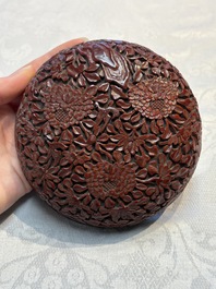 Two Chinese cinnabar lacquer covered boxes and a bottle vase, 19th C.