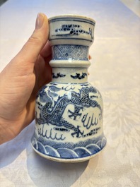 A pair of Chinese blue and white 'Dragons Chasing the Flaming Pearl&rsquo; candlesticks, 19th C.