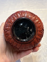 Two Chinese cinnabar lacquer covered boxes and a bottle vase, 19th C.