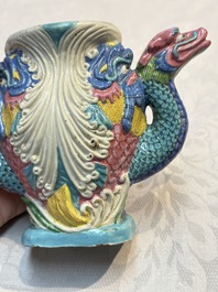 A Chinese famille rose ewer in the form of a dragon and two carps with wooden cover and stand, 19th C.