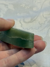 A Chinese celadon jade snuff bottle, a plaque and a ritual stick, Han and later