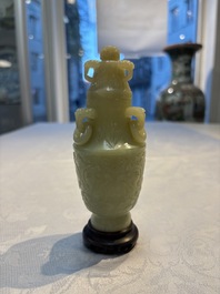 A Chinese celadon jade covered vase, with wooden stand, and a bowl with wooden cover and stand, 19/20th C.