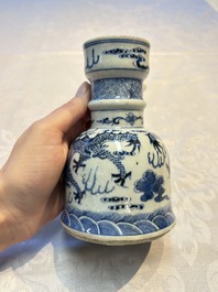 A pair of Chinese blue and white 'Dragons Chasing the Flaming Pearl&rsquo; candlesticks, 19th C.