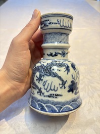 A pair of Chinese blue and white 'Dragons Chasing the Flaming Pearl&rsquo; candlesticks, 19th C.