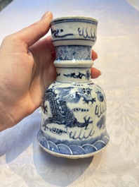 A pair of Chinese blue and white 'Dragons Chasing the Flaming Pearl&rsquo; candlesticks, 19th C.