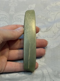 A Chinese celadon jade snuff bottle, a plaque and a ritual stick, Han and later