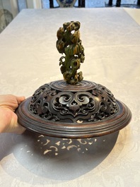 An impressive Chinese famille rose 'Bajixiang and Lotus Scroll' tripod censer with a wooden cover, Jiaqing mark and of the period