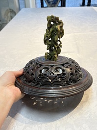 An impressive Chinese famille rose 'Bajixiang and Lotus Scroll' tripod censer with a wooden cover, Jiaqing mark and of the period