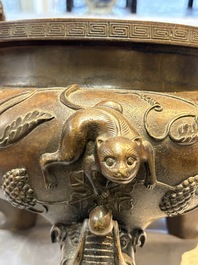A rare Chinese bronze tripod censer with relief mythical animal and grape design, Xuande mark, 19th C.