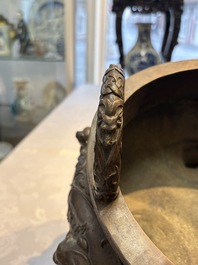 A rare Chinese bronze tripod censer with relief mythical animal and grape design, Xuande mark, 19th C.