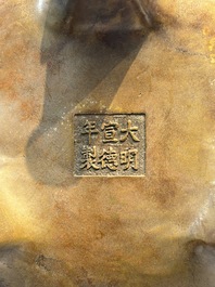 A rare Chinese bronze tripod censer with relief mythical animal and grape design, Xuande mark, 19th C.