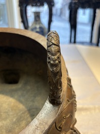 A rare Chinese bronze tripod censer with relief mythical animal and grape design, Xuande mark, 19th C.