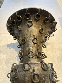 A Chinese archaistic bronze 'Zun' vase with 99 rings, 18/19th C.