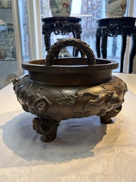 A rare Chinese bronze tripod censer with relief mythical animal and grape design, Xuande mark, 19th C.