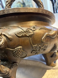 A rare Chinese bronze tripod censer with relief mythical animal and grape design, Xuande mark, 19th C.