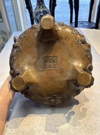 A rare Chinese bronze tripod censer with relief mythical animal and grape design, Xuande mark, 19th C.