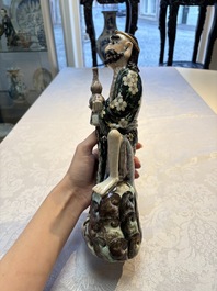 A pair of Chinese famille verte covered jars, a Tieguai Li figure, a blue and white teapot and a biscuit saucer, Kangxi and Qing Yu Tang mark, 19th C.