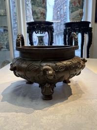 A rare Chinese bronze tripod censer with relief mythical animal and grape design, Xuande mark, 19th C.