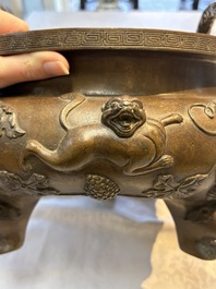 A rare Chinese bronze tripod censer with relief mythical animal and grape design, Xuande mark, 19th C.