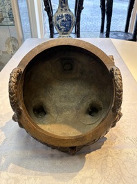 A rare Chinese bronze tripod censer with relief mythical animal and grape design, Xuande mark, 19th C.