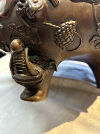 A rare Chinese bronze tripod censer with relief mythical animal and grape design, Xuande mark, 19th C.