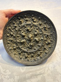 Two Chinese bronze mirrors, one inscribed &lsquo;Fu Shan Shou Hai 福山壽海' and the other with sea animals and grape design, Qing