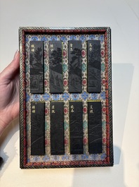 A set of eight Chinese 'Yu Zhi Min Sheng Zai Qin Shi 御製民生在勤詩' ink cakes with a gilt-lacquered 'dragon' box, Hu Kaiwen 胡開文 mark, 20th C.