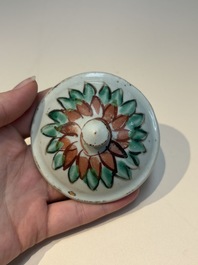 A Chinese wucai &lsquo;Buddhist Lion&rsquo; vase and cover, Transitional period