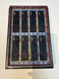 A set of eight Chinese 'Yu Zhi Min Sheng Zai Qin Shi 御製民生在勤詩' ink cakes with a gilt-lacquered 'dragon' box, Hu Kaiwen 胡開文 mark, 20th C.