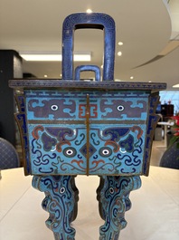 A pair of Chinese cloisonn&eacute; 'Fangding' censers and covers with Taotie design on carved wooden stands, 19th C.
