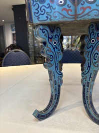 A pair of Chinese cloisonn&eacute; 'Fangding' censers and covers with Taotie design on carved wooden stands, 19th C.