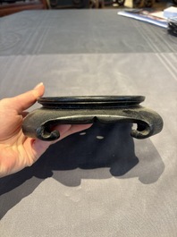 A collection of 38 Chinese wooden stands and a box, 19/20th C.