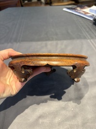 A collection of 38 Chinese wooden stands and a box, 19/20th C.