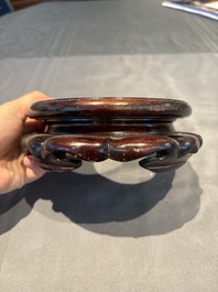 A collection of 38 Chinese wooden stands and a box, 19/20th C.