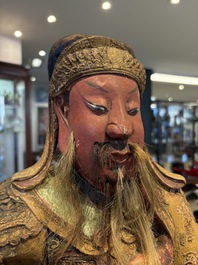 A large Chinese gilt-lacquered and polychrome wooden figure of Guandi, 19th C.